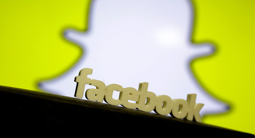 facebook logo is seen in front of a displayed snapchat logo