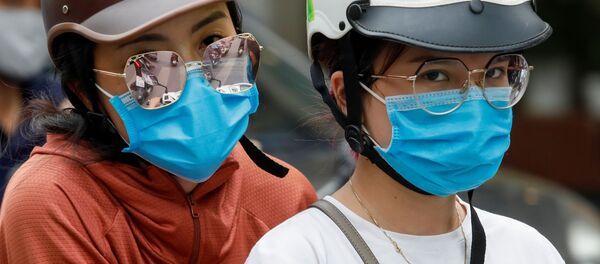 Девушки в защитных масках во Вьетнаме - 俄罗斯卫星通讯社