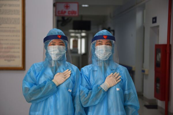 Медицинские работники в защитной одежде позируют во временном центре тестирования на коронавирус COVID-19 в Ханое, Вьетнам - 俄羅斯衛星通訊社