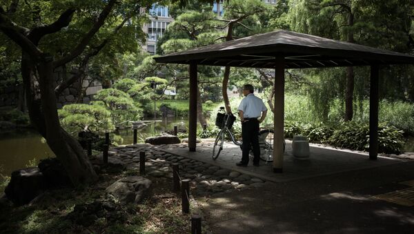 Мужчина отдыхает в тени парка во время аномальной жары в Токио - 俄罗斯卫星通讯社
