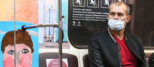 Мужчина в защитной маске в вагоне Московского метрополитена.  - 俄羅斯衛星通訊社
