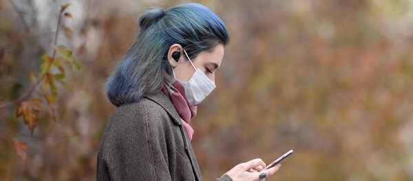 Девушка в защитной маске на одной из улиц в Москве. - 俄罗斯卫星通讯社