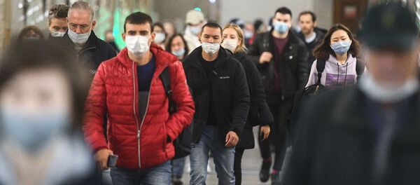 Пассажиры в защитных масках на одной из станций Московского метрополитена.  - 俄罗斯卫星通讯社