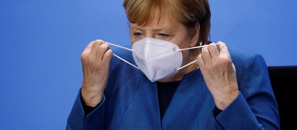 Канцлер Германии Ангела Меркель надевает защитную маску Канцлер Германии Ангела Меркель надевает защитную маску - 俄罗斯卫星通讯社