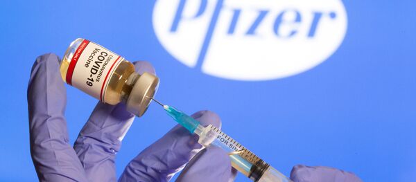 Бутылочка с вакциной от коронавируса на фоне логотпипа Pfizer - 俄羅斯衛星通訊社