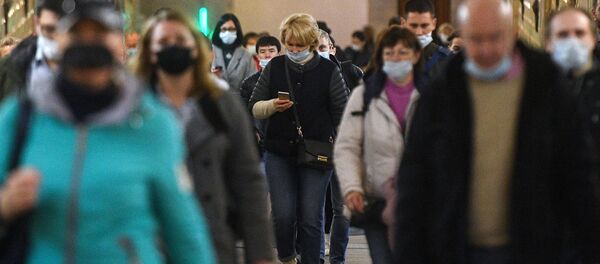 Пассажиры в защитных масках на одной из станций Московского метрополитена.  - 俄罗斯卫星通讯社
