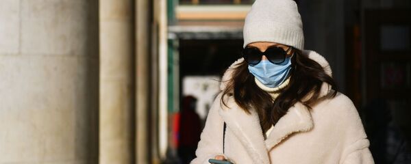 Девушка в медицинской маске у станции метро Новослободская Кольцевой линии московского метрополитена.  - 俄罗斯卫星通讯社