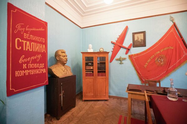 А это кабинет партийного работника — со знаменами, вымпелами, бюстом Сталина, моделями самолетов. - 俄羅斯衛星通訊社