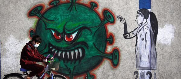 Граффити с изображением медсестры, вводящей вакцину против COVID-19, в городе Газа - 俄羅斯衛星通訊社