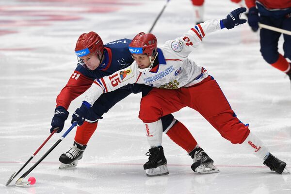 挪威冰球队员尤纳斯·特耶姆斯塔德与俄罗斯队员米哈伊尔·谢尔盖耶夫在2019年大学生冬奥会比赛中拼抢。 - 俄罗斯卫星通讯社