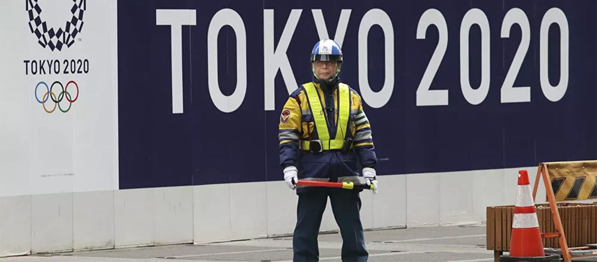 Охранник на фоне баннера олимпийских игр в Токио - 俄羅斯衛星通訊社, 1920, 20.06.2021