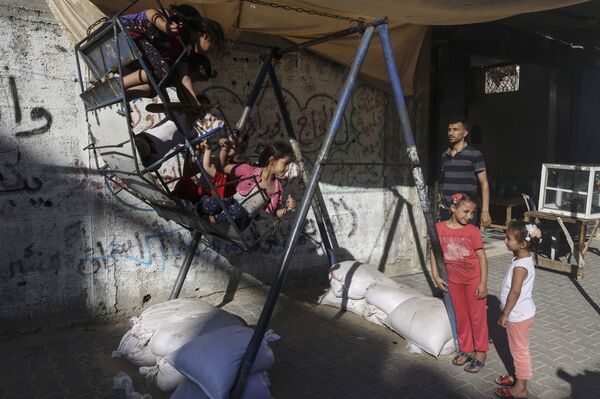 一群在荡秋千的加沙儿童。
 - 俄罗斯卫星通讯社