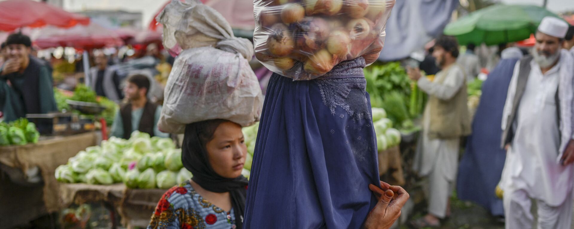 Женщина в парандже несет на голове мешок с луком на рынке в Кабуле - 俄羅斯衛星通訊社, 1920, 26.07.2022