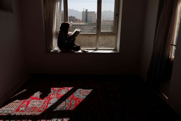20岁的女学生哈瓦在窗台上阅读书籍。 - 俄罗斯卫星通讯社