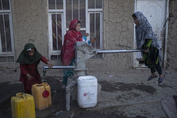 阿富汗喀布尔，女童们在流亡人员收容营里给水桶灌满水。 - 俄罗斯卫星通讯社