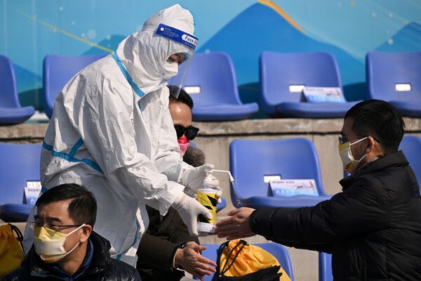 北京冬奥会工作人员为进场观众提供消毒洗手液服务。 - 俄罗斯卫星通讯社