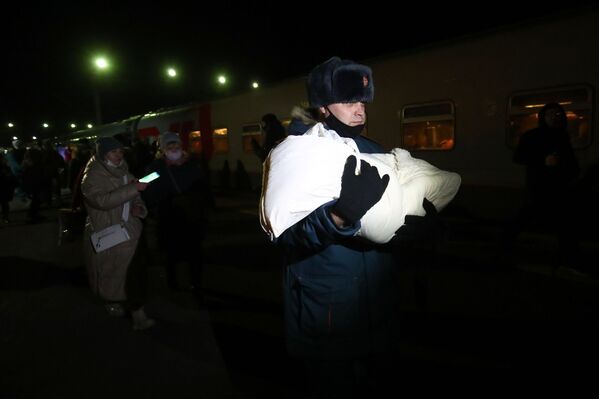 俄羅斯緊急情況部工作人員懷抱著頓巴斯嬰兒走出伏爾加火車站。 - 俄羅斯衛星通訊社