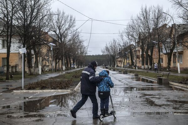 一对父子走上获得解放的夏斯季耶市街道。 - 俄罗斯卫星通讯社