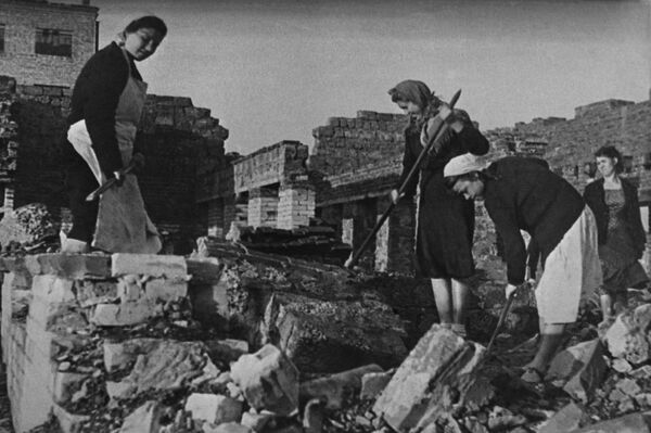 斯大林格勒战役（1943年）结束后开展重建工作。苏联妇女在损毁的城市街道上开展清理工作。 - 俄罗斯卫星通讯社