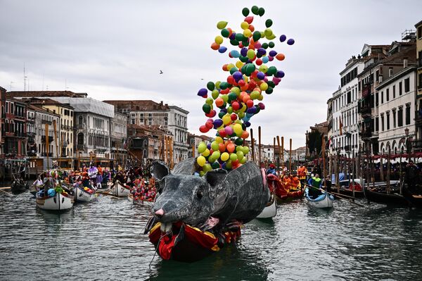 2月5日，威尼斯狂欢节期间，狂欢者聚集在大运河参加威尼斯赛艇协会协调会的水上游行时，从码头船只上飞出彩色的气球。 - 俄罗斯卫星通讯社