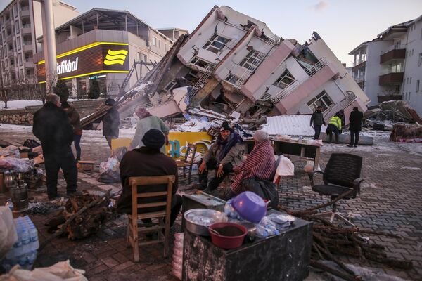 2023年2月8日，土耳其南部阿迪亚曼省的格尔巴舍市，一栋倒塌建筑物周围的人们。 - 俄罗斯卫星通讯社
