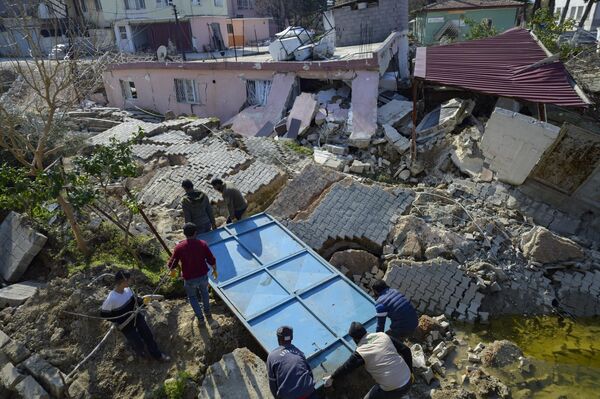 土耳其地震灾区的居民在废墟中捡拾钢架。 - 俄罗斯卫星通讯社