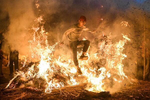 2023年2月28日，在中國廣東省南部的揭陽市，一名男子跳過篝火，以擺脫厄運。 - 俄羅斯衛星通訊社