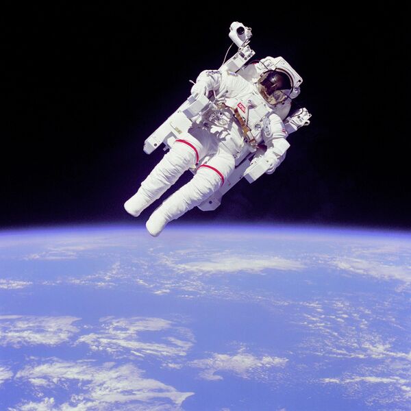 宇航員布魯斯·麥克坎德雷斯二世進行艙外活動，距離挑戰者號航天飛機機艙有數米遠。他正在使用一個氮氣推進的手控“載人機動裝置”(Manned Maneuvering Unit,簡稱MMU)。這是一次無系繩的太空行走。 - 俄羅斯衛星通訊社