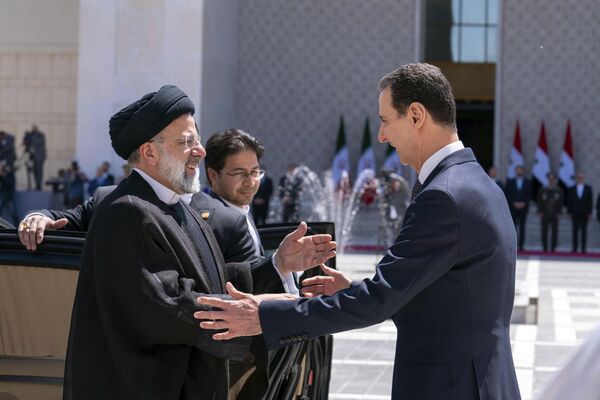 在叙利亚总统Facebook官方账号上发布的这张照片中，叙利亚总统巴沙尔·阿萨德(右)于2023年5月3日星期三在叙利亚大马士革欢迎伊朗总统易卜拉欣·莱希。据伊朗官方媒体报道，伊朗总统莱西星期三在大马士革会见了叙利亚总统阿萨德，以促进两个盟国之间的合作。(叙利亚总统Facebook官方账号/美联社摄) - 俄罗斯卫星通讯社