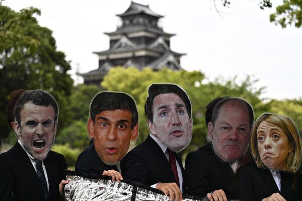 在G7峰会前，环保主义人士手持法国总统马克龙、英国首相苏纳克、加拿大总理特鲁多、德国总理朔尔茨和意大利总理梅洛尼头像抗议“日本肮脏能源政策”。 - 俄罗斯卫星通讯社
