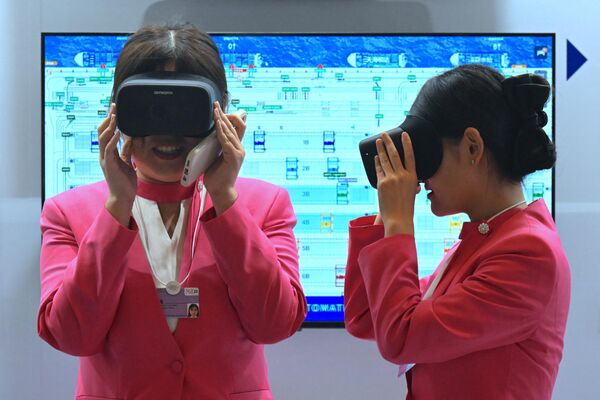 2023年6月28日，两名志愿者在梅江会展中心“智慧零碳”集装箱码头展位上使用VR眼镜。 - 俄罗斯卫星通讯社