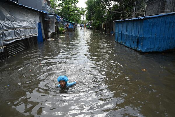 緬甸仰光，暴雨過後，一個男孩在被洪水淹沒的街道上游泳。 - 俄羅斯衛星通訊社