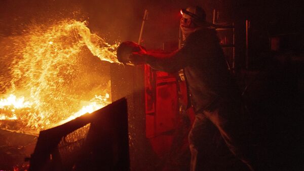 Мужчина тушит пламя лесного пожара в Агуанге, Калифорния - 俄罗斯卫星通讯社