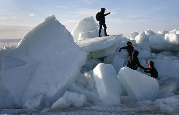 在濱海邊疆區阿穆爾灣海岸因強風形成的冰丘附近的人們。 - 俄羅斯衛星通訊社