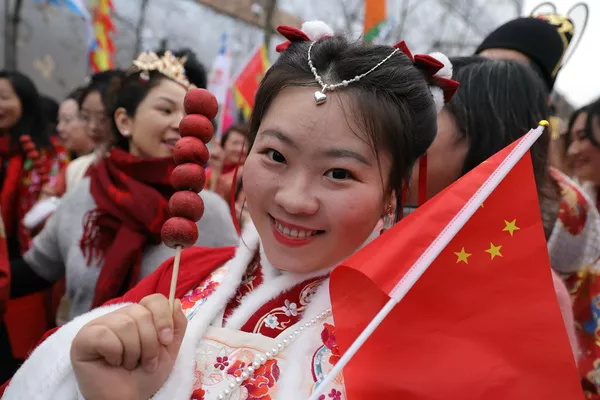 巴黎香榭丽舍大街，一名员工在马尼拉唐人街区的一家商场为她的同事戴上中国发簪。迎接2月10日的农历龙年春节。