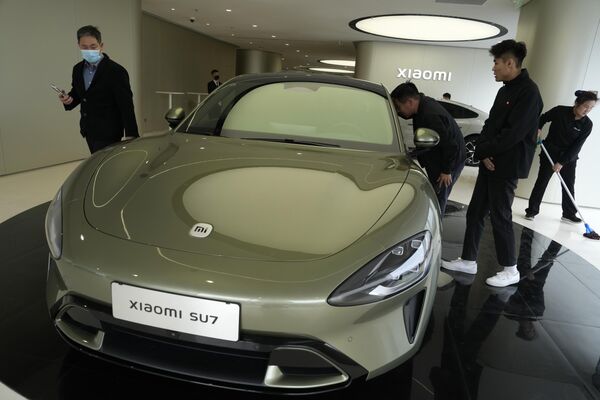 2024年3月26日，星期二，在北京小米汽车旗舰店，参观者们在观看小米SU7电动汽车。中国智能手机制造商小米宣布将于2024年3月28日推出首款电动汽车。 - 俄罗斯卫星通讯社