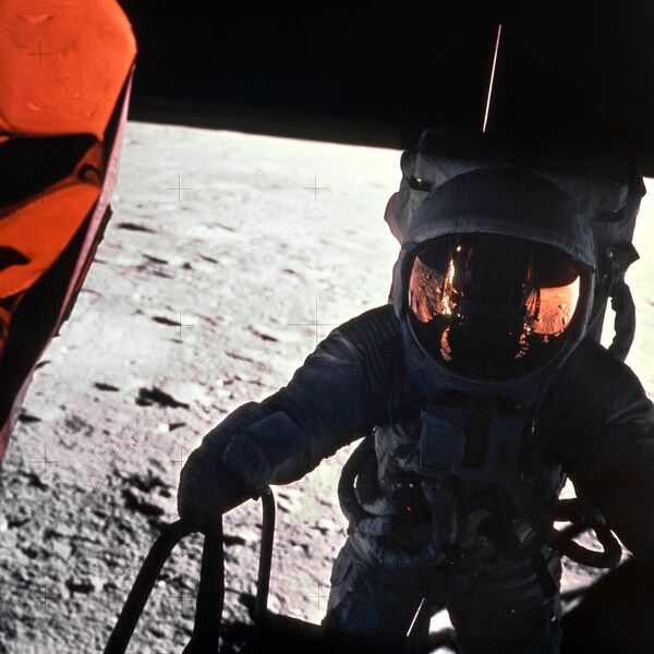 美國宇航局 (NASA) 發佈一張拍攝於1969年11月19日的檔案照片：阿波羅12號執行太空任務的一名宇航員攜帶相機前往月球。另一名宇航員的影子反射在其頭盔上。 - 俄羅斯衛星通訊社