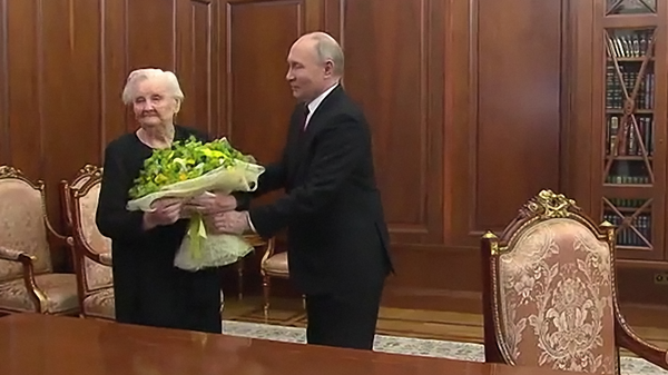 俄总统普京在就职典礼结束后于克里姆林宫举行的会见活动上向自己的中学老师薇拉·古列维奇献花（视频帧） - 俄罗斯卫星通讯社