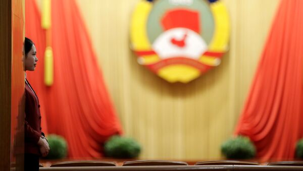 An attendant stands ahead of the closing session of the Chinese People's Political Consultative Conference - 俄羅斯衛星通訊社