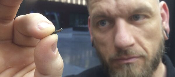 Jowan Osterlund from Biohax Sweden, holds a small microchip implant, similar to those implanted into workers at the Epicenter digital innovation business centre - 俄罗斯卫星通讯社