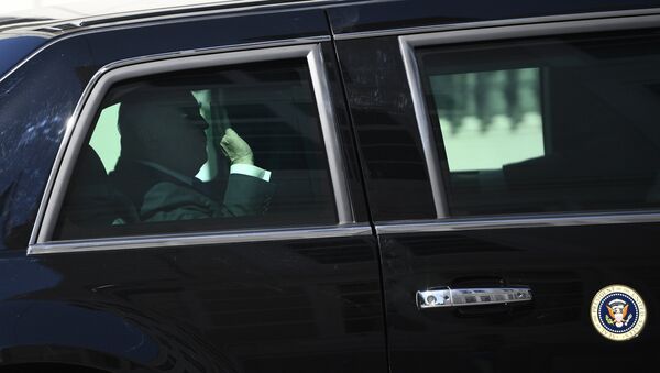 US President Donald Trump gestures while riding in the US Presidential state car The Beast - 俄羅斯衛星通訊社