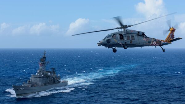 A U.S. MH-60S Sea Hawk flies by Japan's Maritime Self-Defense Force ship JS Shimakaze above waters around Okinawa southwest of the Korean peninsula - 俄羅斯衛星通訊社