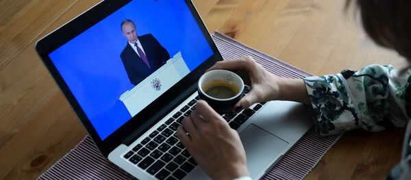 Девушка у себя в квартире в Новосибирске смотрит трансляцию ежегодного послания президента РФ Владимира Путина к Федеральному собранию - 俄罗斯卫星通讯社