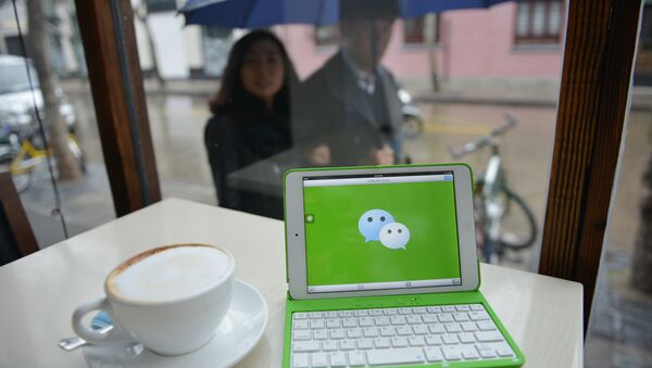 The logo of Chinese instant messaging platform called WeChat on a mobile device - 俄羅斯衛星通訊社
