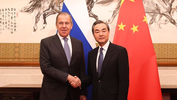 Russia's Foreign Minister Sergei Lavrov shakes hands with Chinese State Councilor and Foreign Minister Wang Yi at the Diaoyutai State Guest House in Beijing - 俄羅斯衛星通訊社