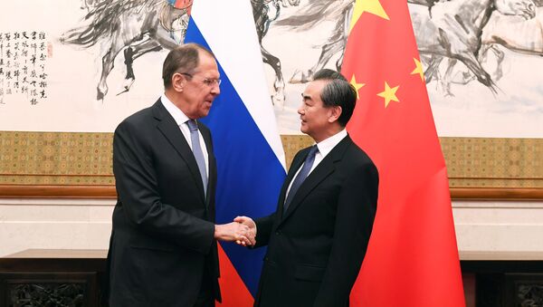 Russian Foreign Minister Sergei Lavrov shakes hands with Chinese State Councilor and Foreign Minister Wang Yi at the Diaoyutai State Guest House in Beijing - 俄羅斯衛星通訊社
