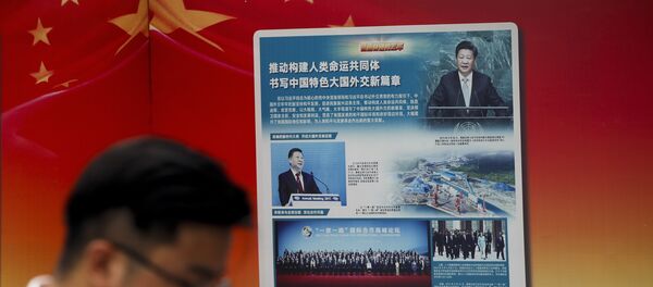 A man walks by a government propaganda billboard promoting Chinese President Xi Jinping's signature One Belt One Road outside a subway station in Beijing A man walks by a government propaganda billboard promoting Chinese President Xi Jinping's signature One Belt One Road outside a subway station in Beijing - 俄罗斯卫星通讯社