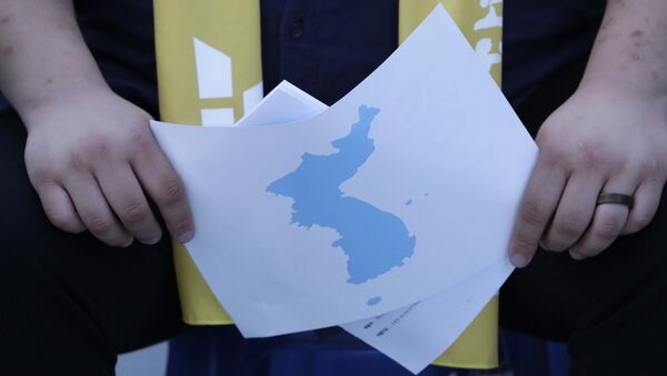 A South Korean holds a map of the Korean peninsula - 俄羅斯衛星通訊社