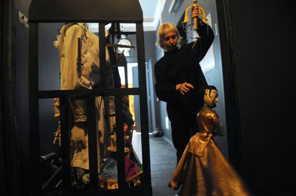 在下層木偶劇院（木偶劇）中，借助於線、桿或金屬絲從上方控制木偶，木偶戲演員通常被上層窗簾或裝飾隱藏在觀眾面前。   照片：在“Grand Voyage”排練期間後台的一個女演員和木偶娃娃 - 俄羅斯衛星通訊社