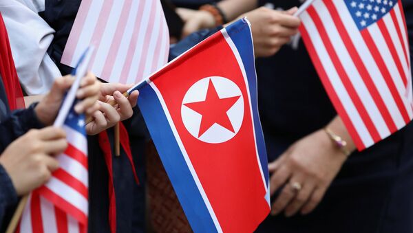 Bystanders holding North Korea and U.S. flags wait for the motorcade of U.S. President Donald Trump in Hanoi - 俄罗斯卫星通讯社